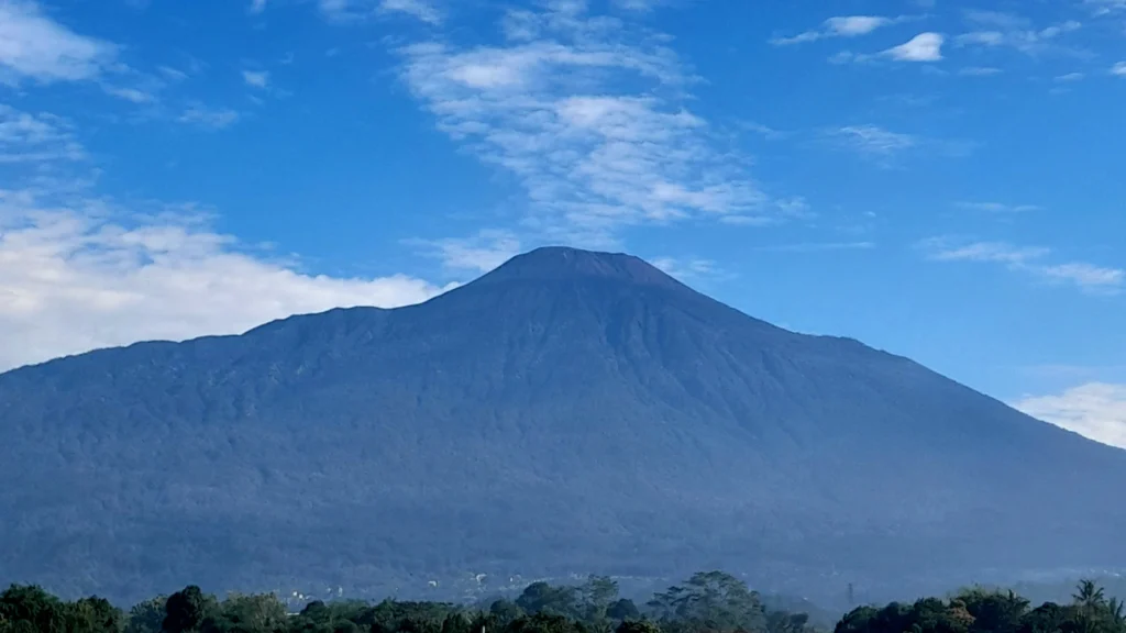 A multi-parameter seismic monitoring station on the rocky slope of Mount Slamet for early warning.