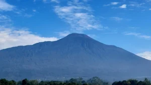 A multi-parameter seismic monitoring station on the rocky slope of Mount Slamet for early warning.
